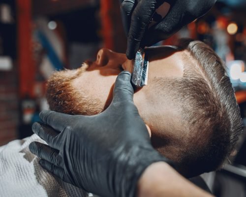 Man with a beard. Hairdresser with a client.